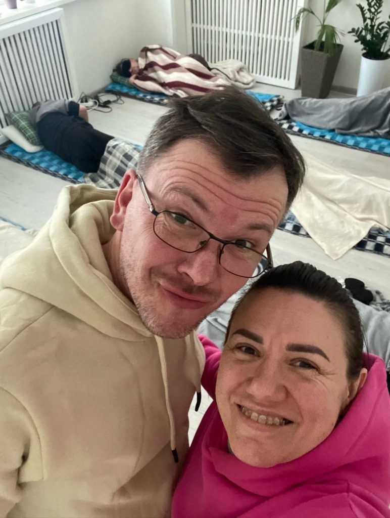 Portrait of psychologists Ivan Dmytryk and Irena Vasiuk, in close-up, in the therapy room. They are smiling at the camera.